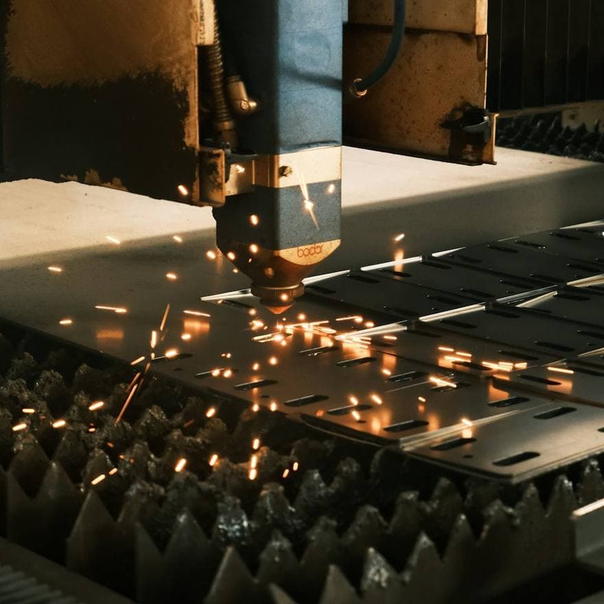 Laser cutting steel plate with a spray of sparks