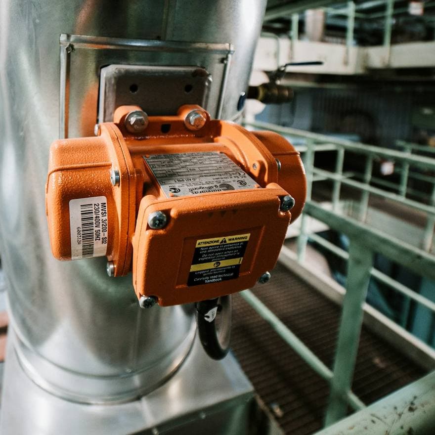 Overhead crane lifting aluminium sheet in a rolling mill